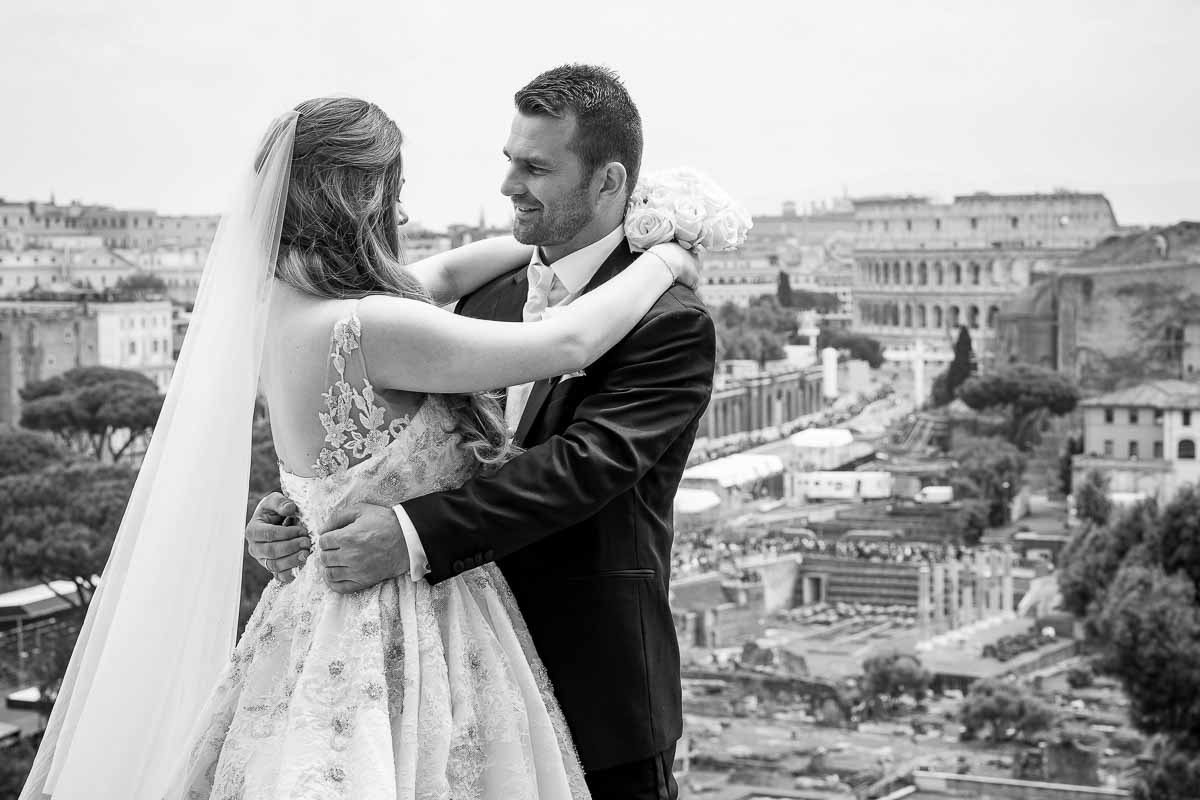 Black n white image conversion as newlyweds stand before the roman skyline in the far distance