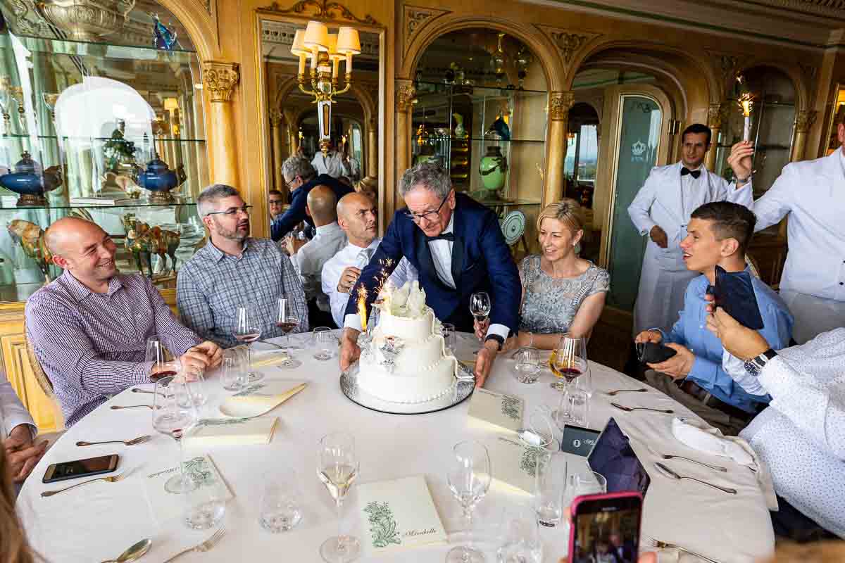 Bringing out the wedding cake on the table before all the guests