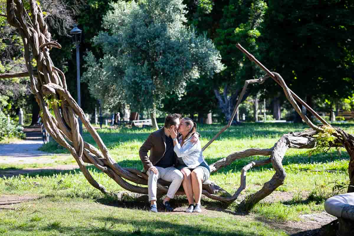 Couple kissing in love in Villa Borghese park