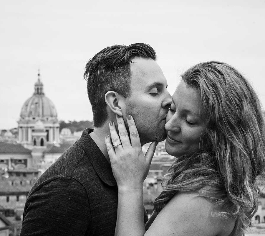 Couple portrait image in black and white with the ancient city of Rome in the background