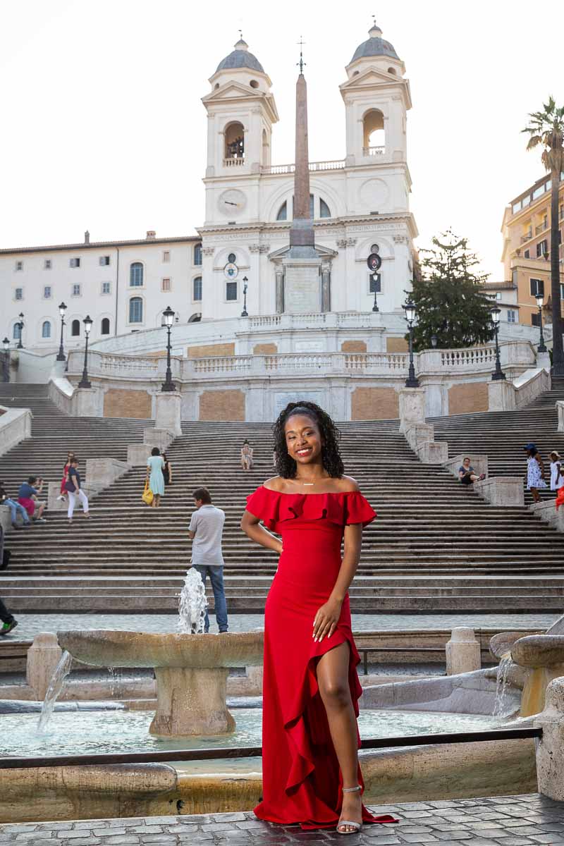 Girl wearing a red dress in front of Piazza di Spagna