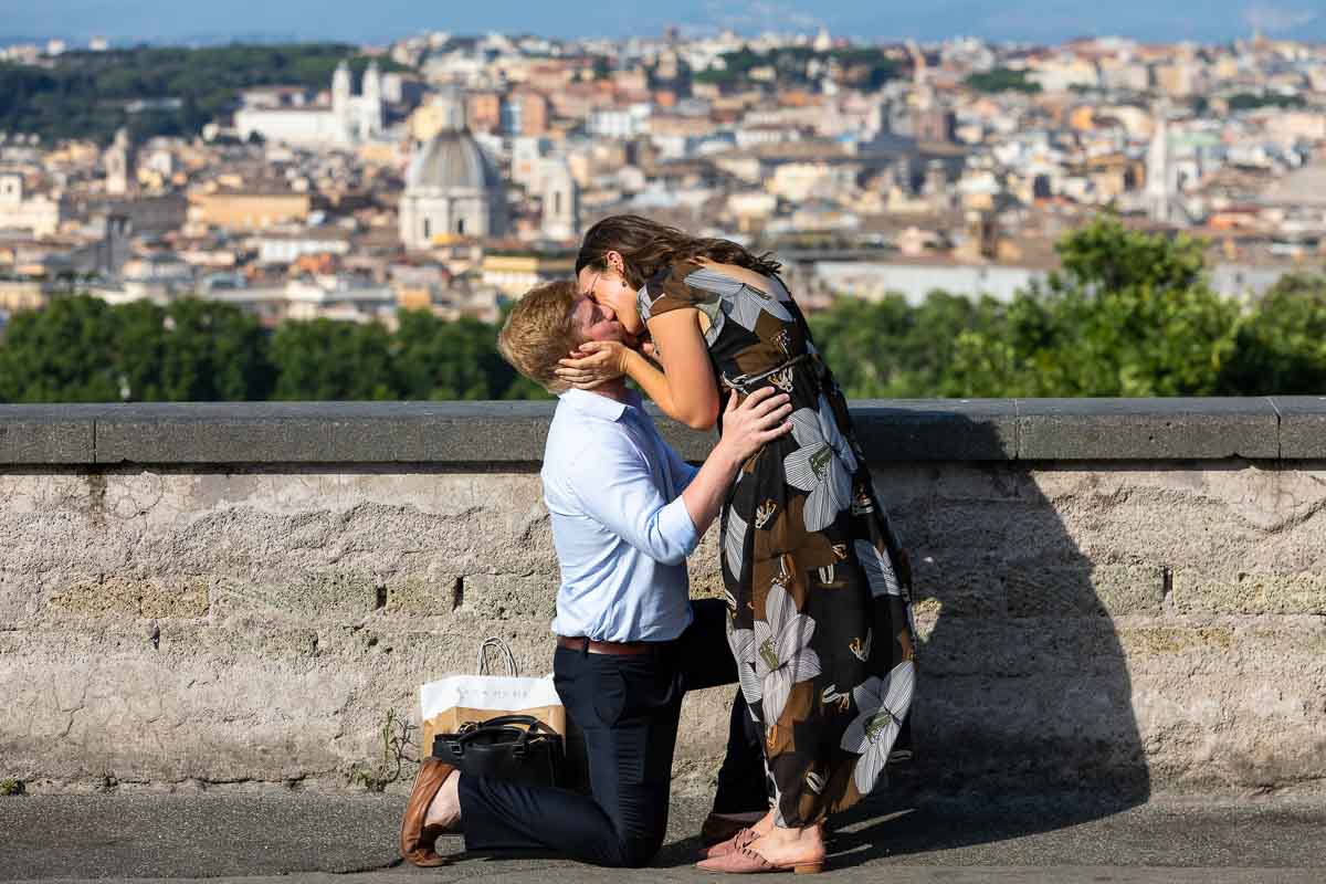 She said yes. Kissing photo of a couple just engaged in Italy