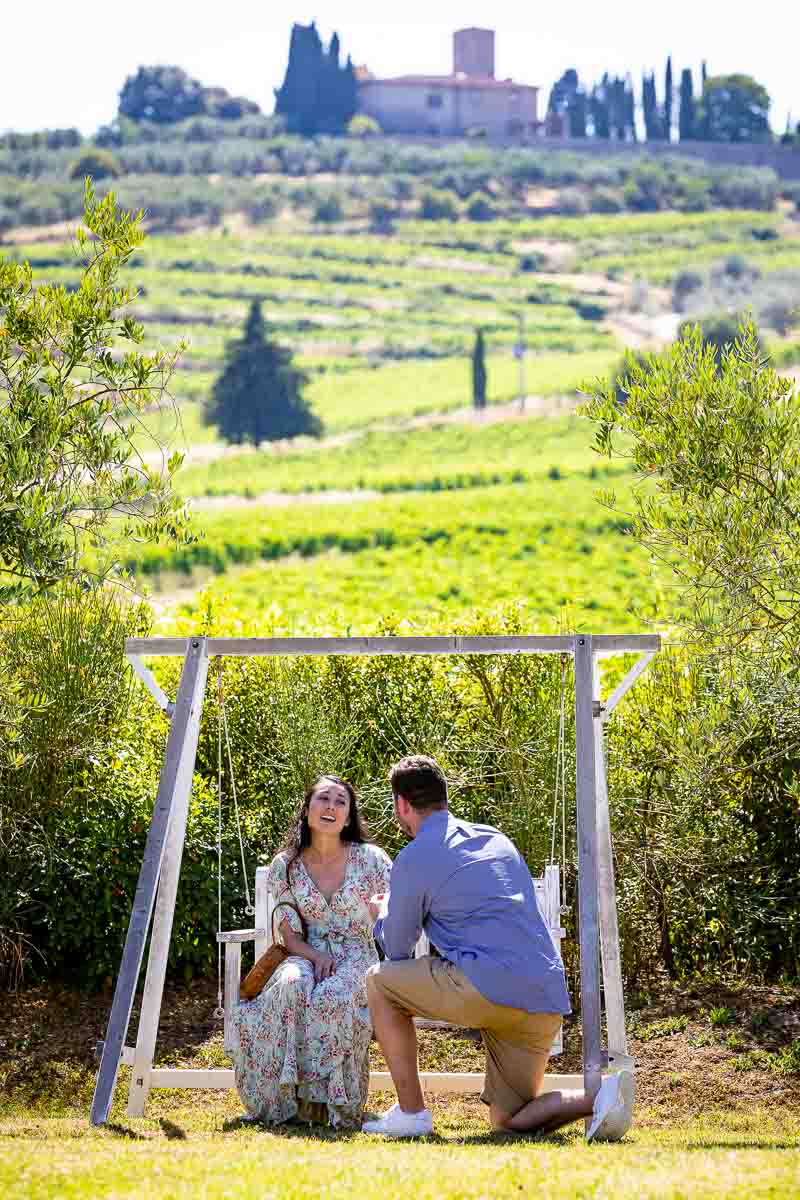 Man kneeling down for a wedding proposal photographed from a distance