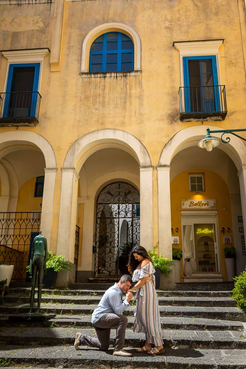 A gesture of chivalry before one of the ancient island yellow buildings