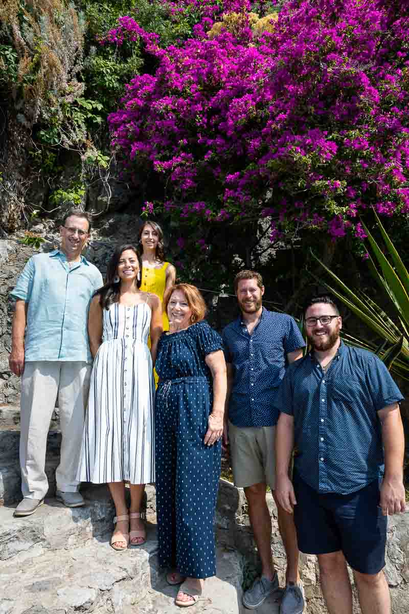 Portrait picture posing in front of nice magenta and purple flowers in Italy