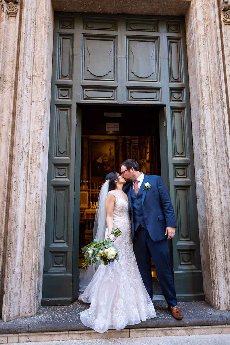 Newlyweds kissing just outside of church. Just Married