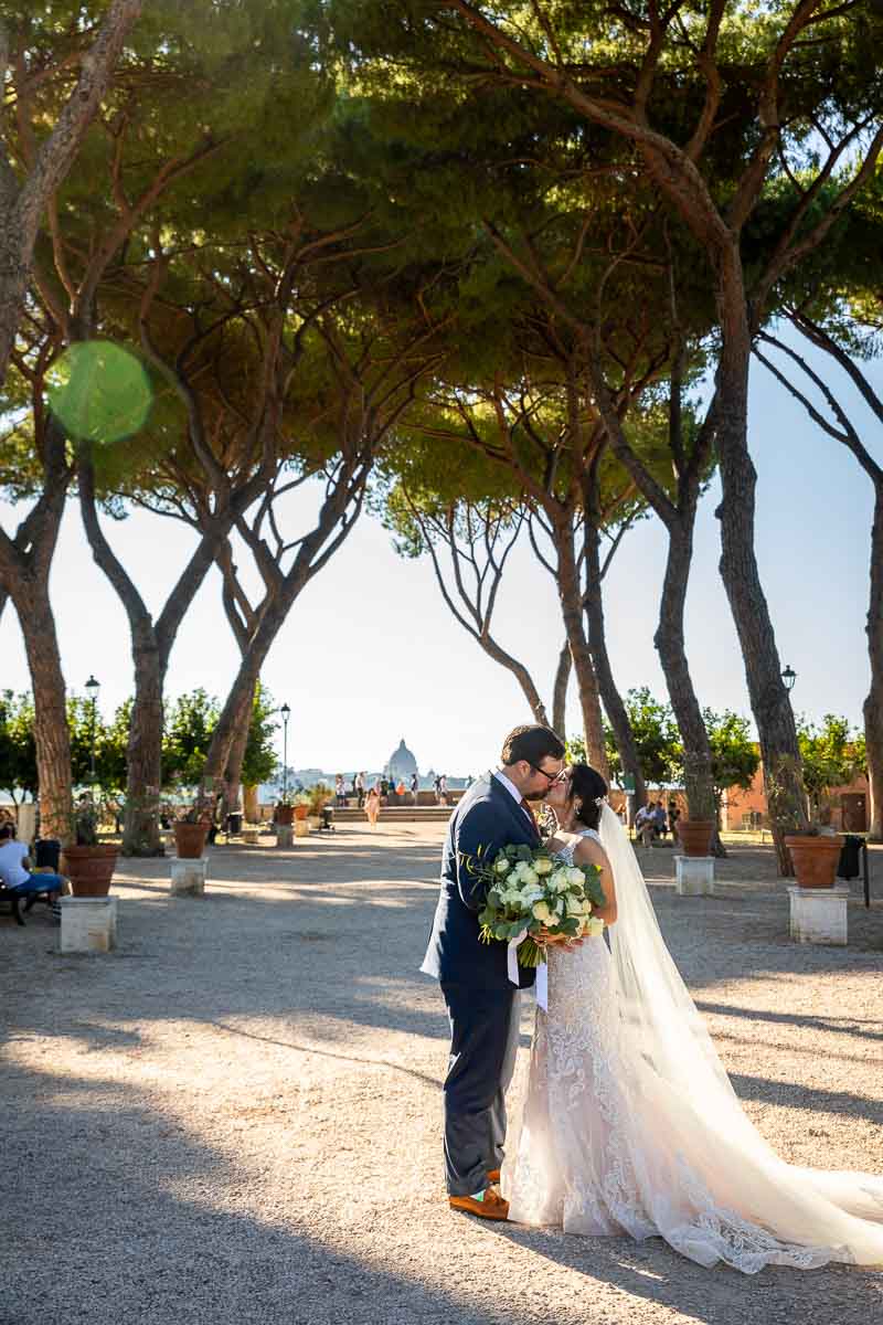 Bride and groom photographed underneath Mediterranean pine trees at Giardino degli Aranci in Rome Italy