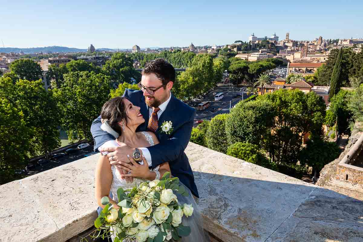 Newlyweds happy in love taking pictures with the roman city in the background