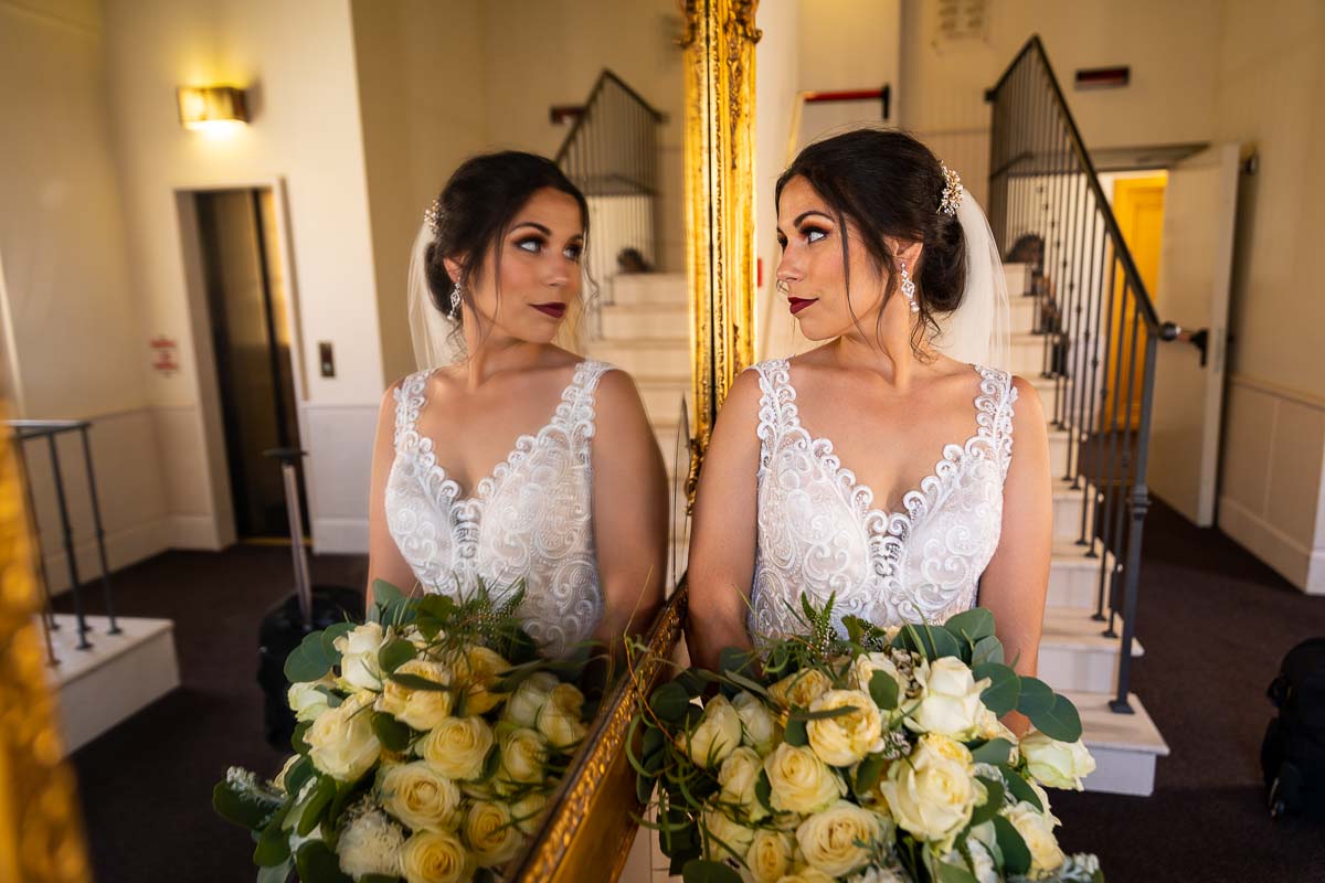 Bride looking into the mirror reflection