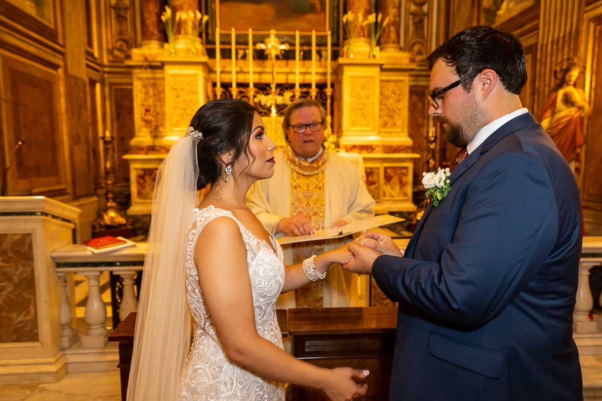 Bride and groom getting married inside roman catholic church