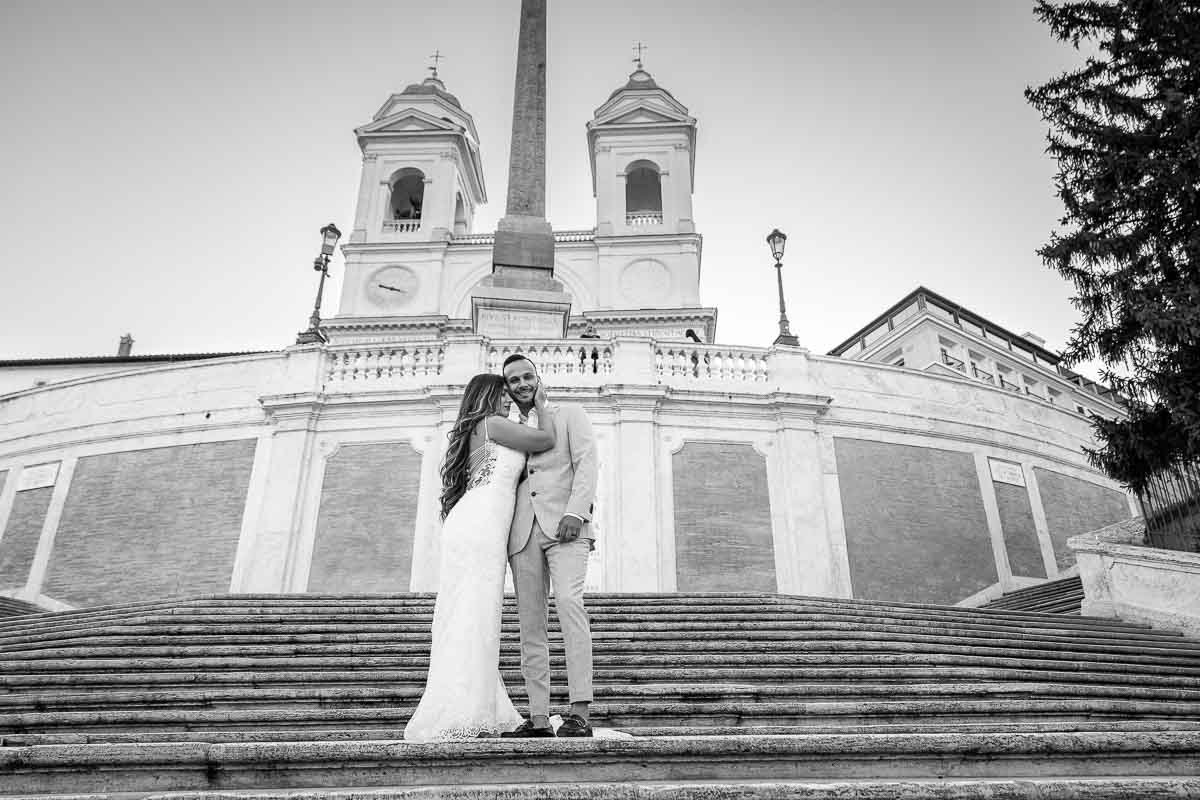 Black & White image of a couple in wedding attire posing on Rome's Spanish steps