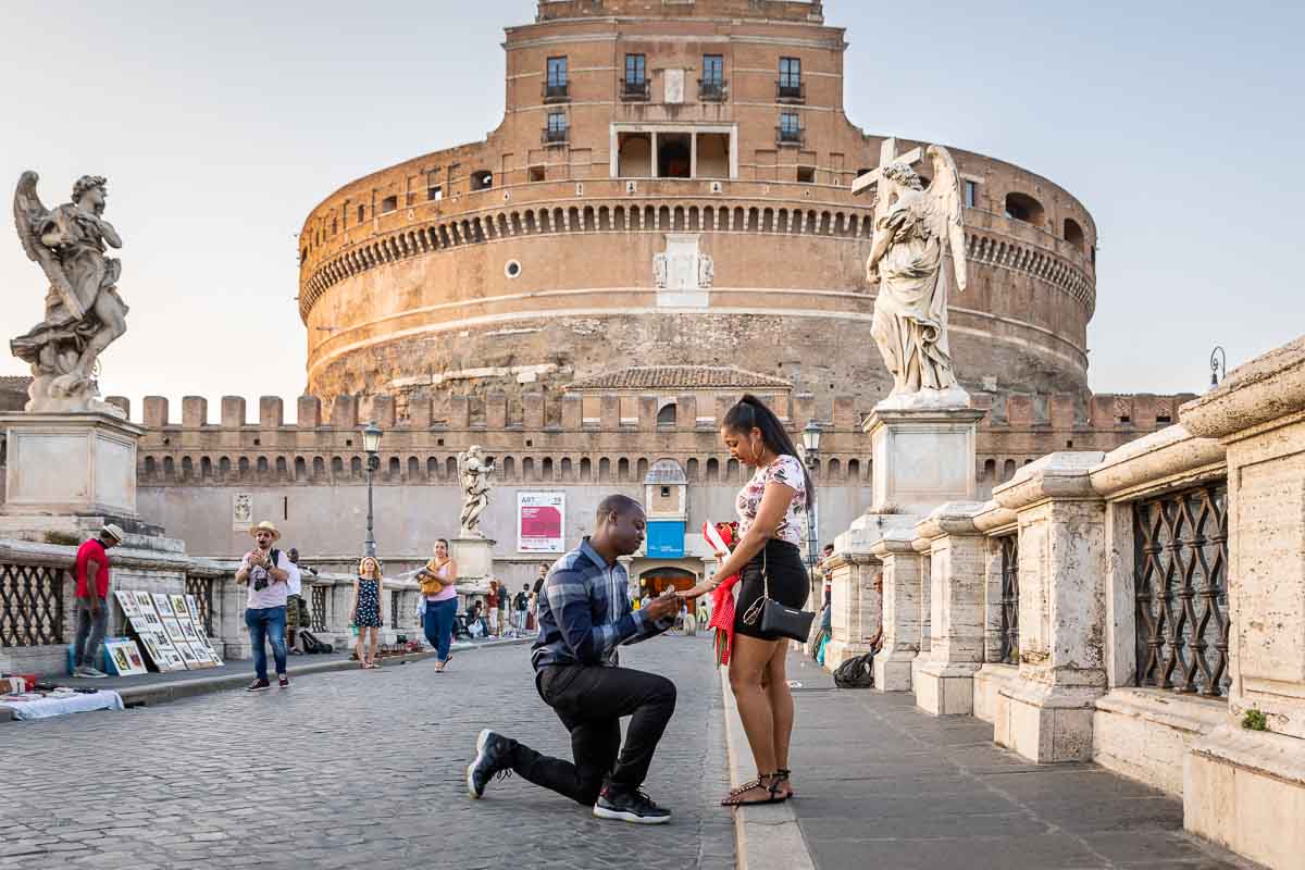 Proposing marriage on the bridge in front of the Sant'Angelo Castle in Rome Italy