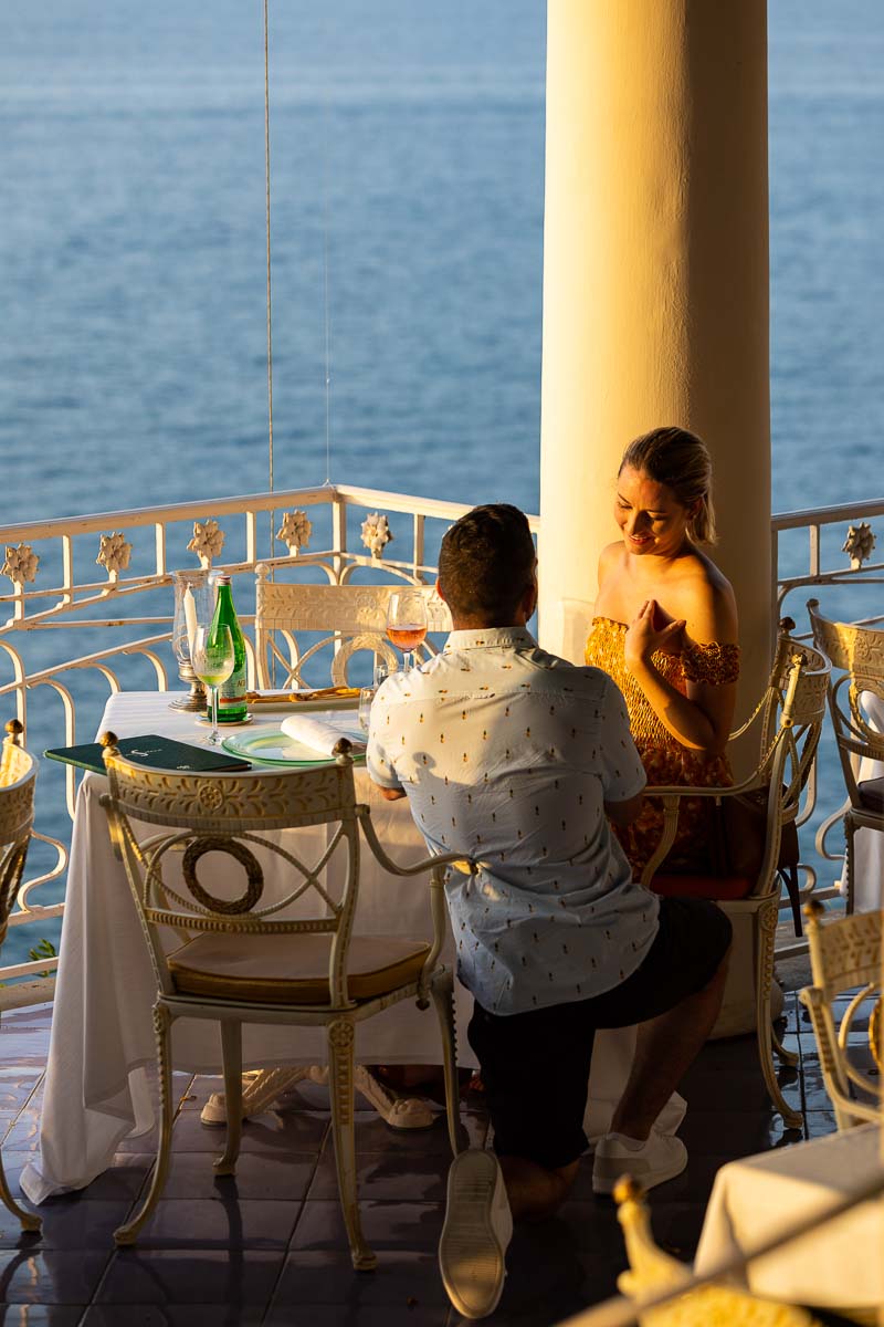 Surprise wedding proposal at the dinner table with one knee down in Sorrento 