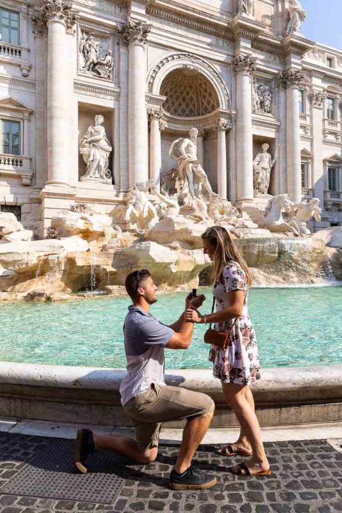 Asking the big question knee down wedding proposal at the Trevi fountain in Rome Italy
