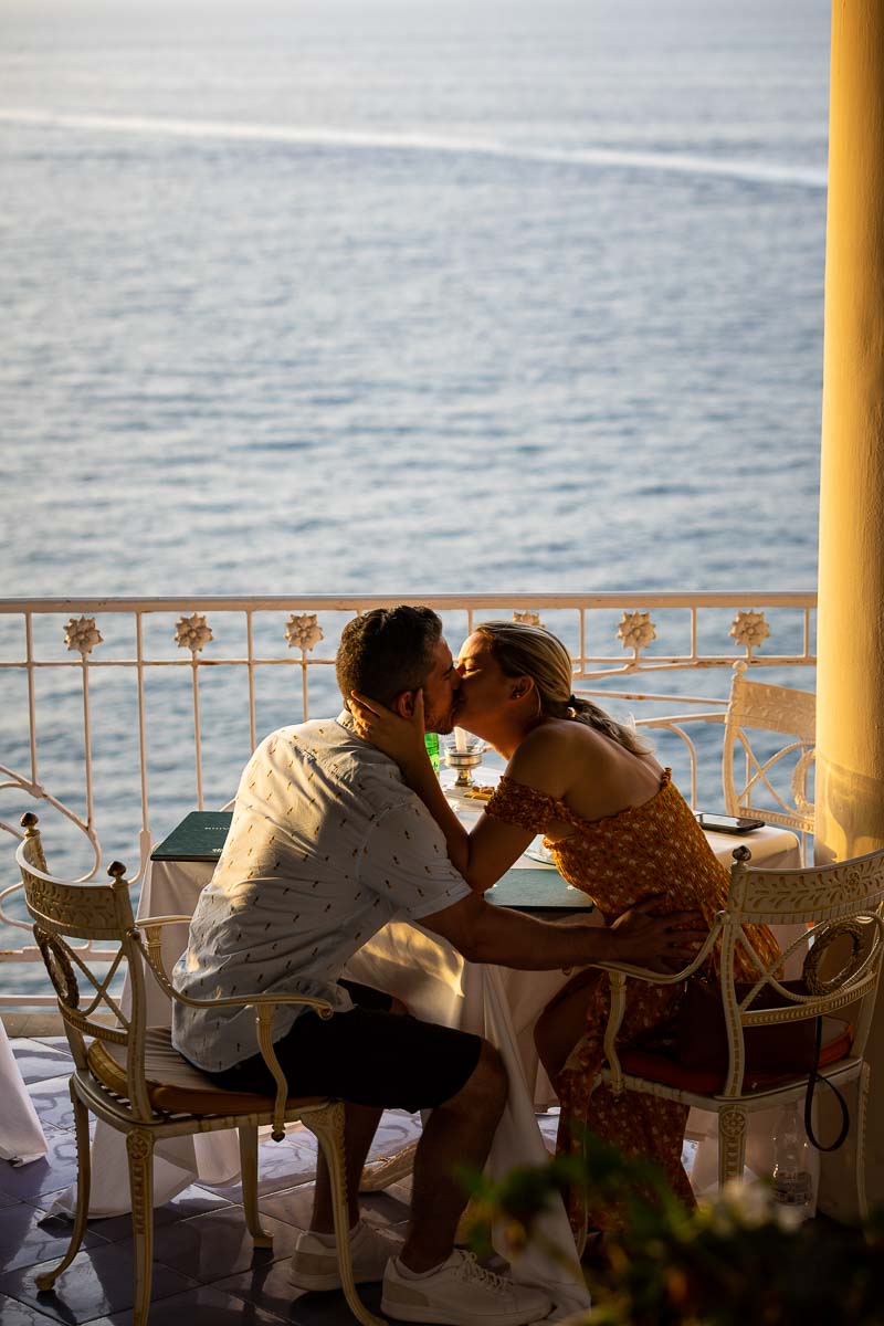 Just engaged in costiera sorrentina Sorrento Italy. Kissing by seaside view after a romantic surprise wedding proposal