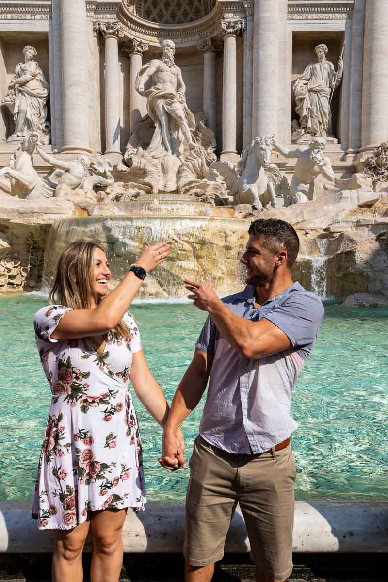 Coin toss picture of a couple just throwing the coins into the fountain