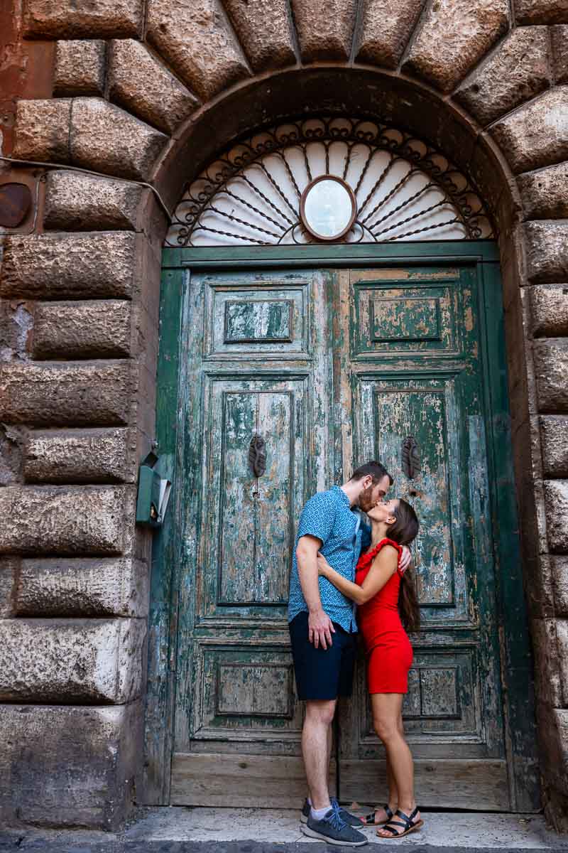 Couple portrait picture photographed in front of an old green doorway found in the city of Rome Italy