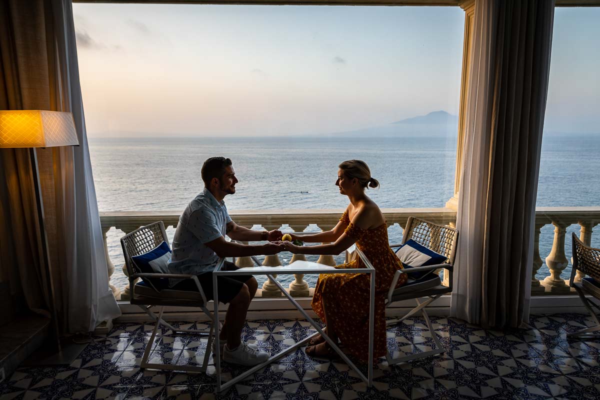 Holding hands side view couple portrait holding hands. Sorrento surprise wedding proposal