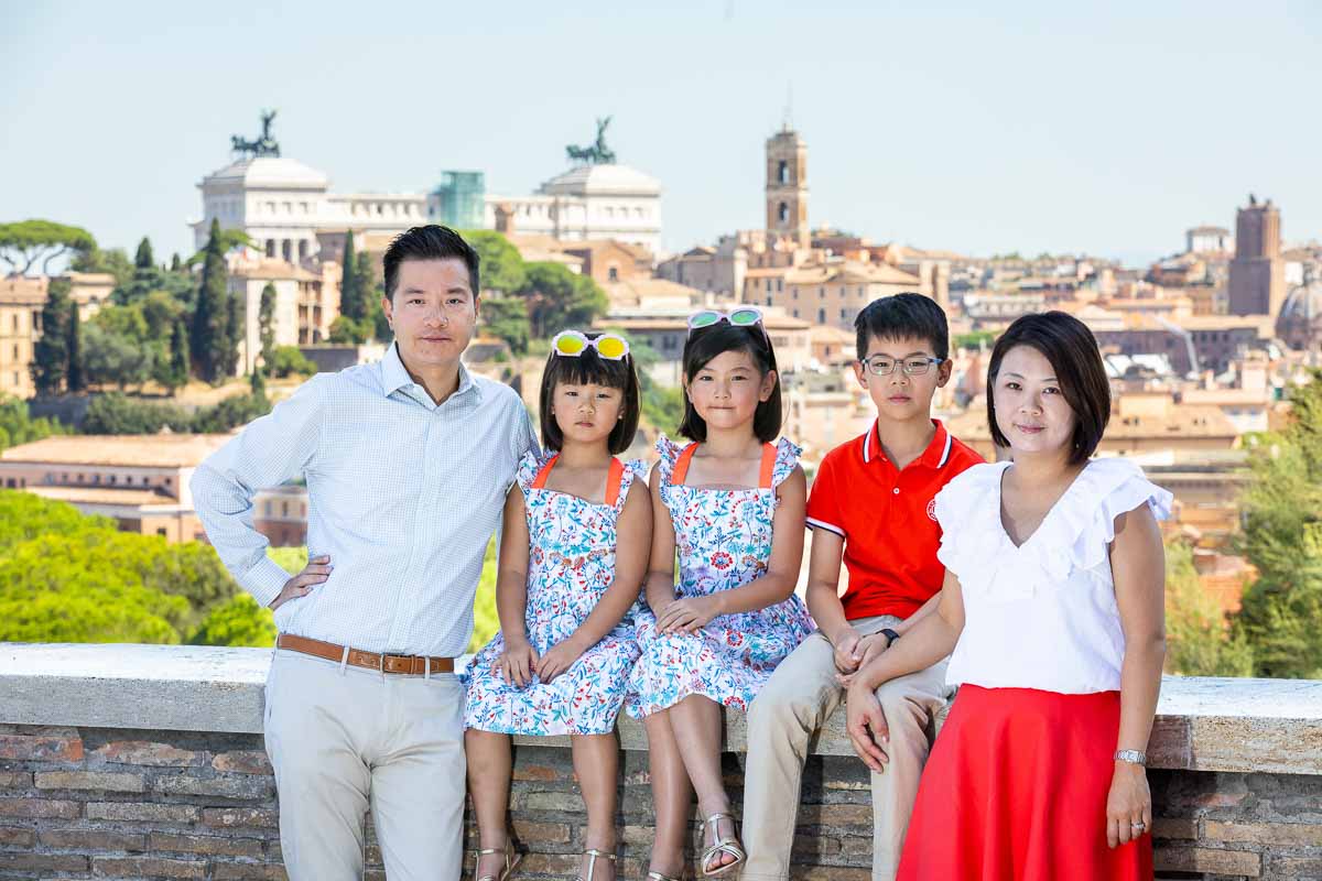 Family portrait with the ancient city view of Rome Italy in the background