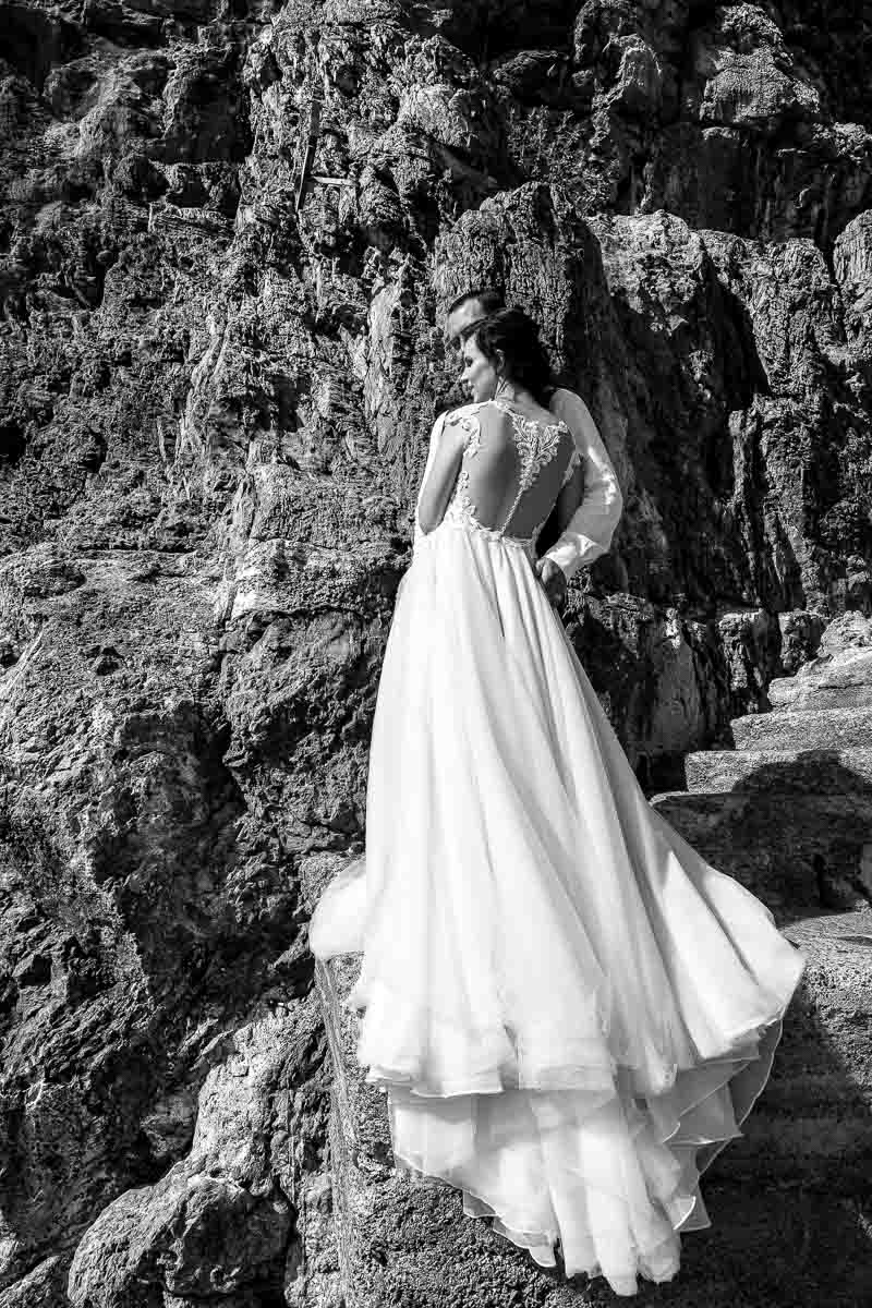 Bridal dress photography in black and white photographed against the rocks