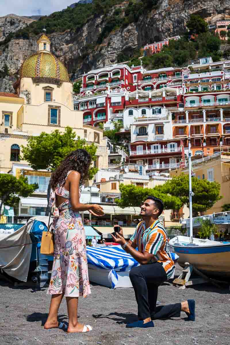 Knee down surprise wedding marriage proposal on the beach of Positano in Italy's Amalfi coast