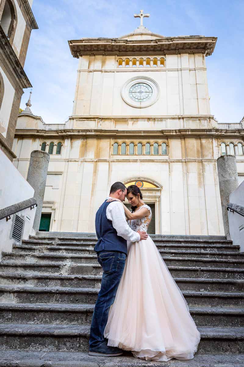 Just married couple posing on the steps of a Cathedral church Elopement Wedding in Positano