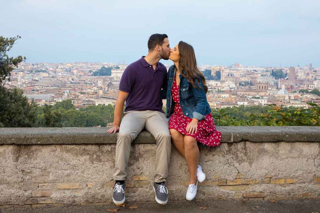 Just engaged in Rome Italy taking engagement pictures with the roman skyline in the background