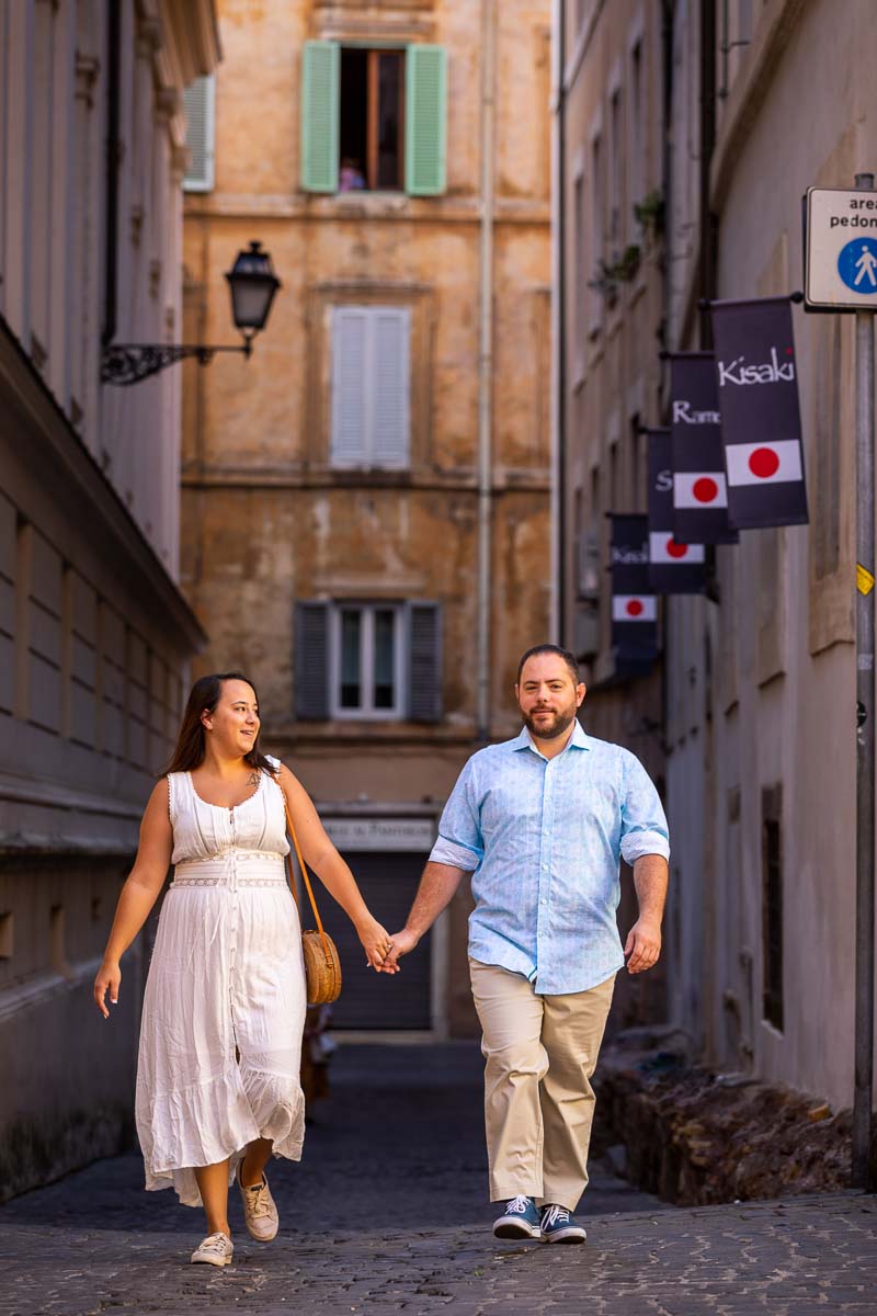 Couple walking the streets of Rome holding hands