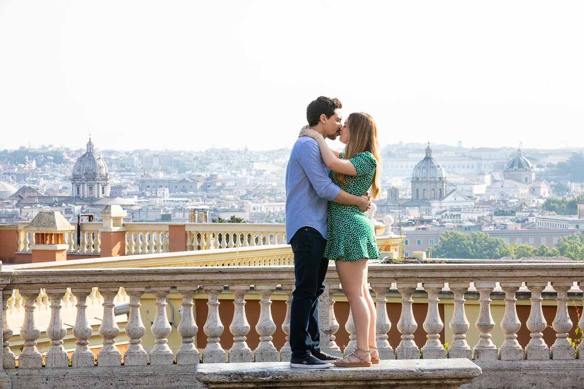 In love over the ancient city of Rome posing on a marble bench with the city view crisp clear in the backdrop Rome photoshooting