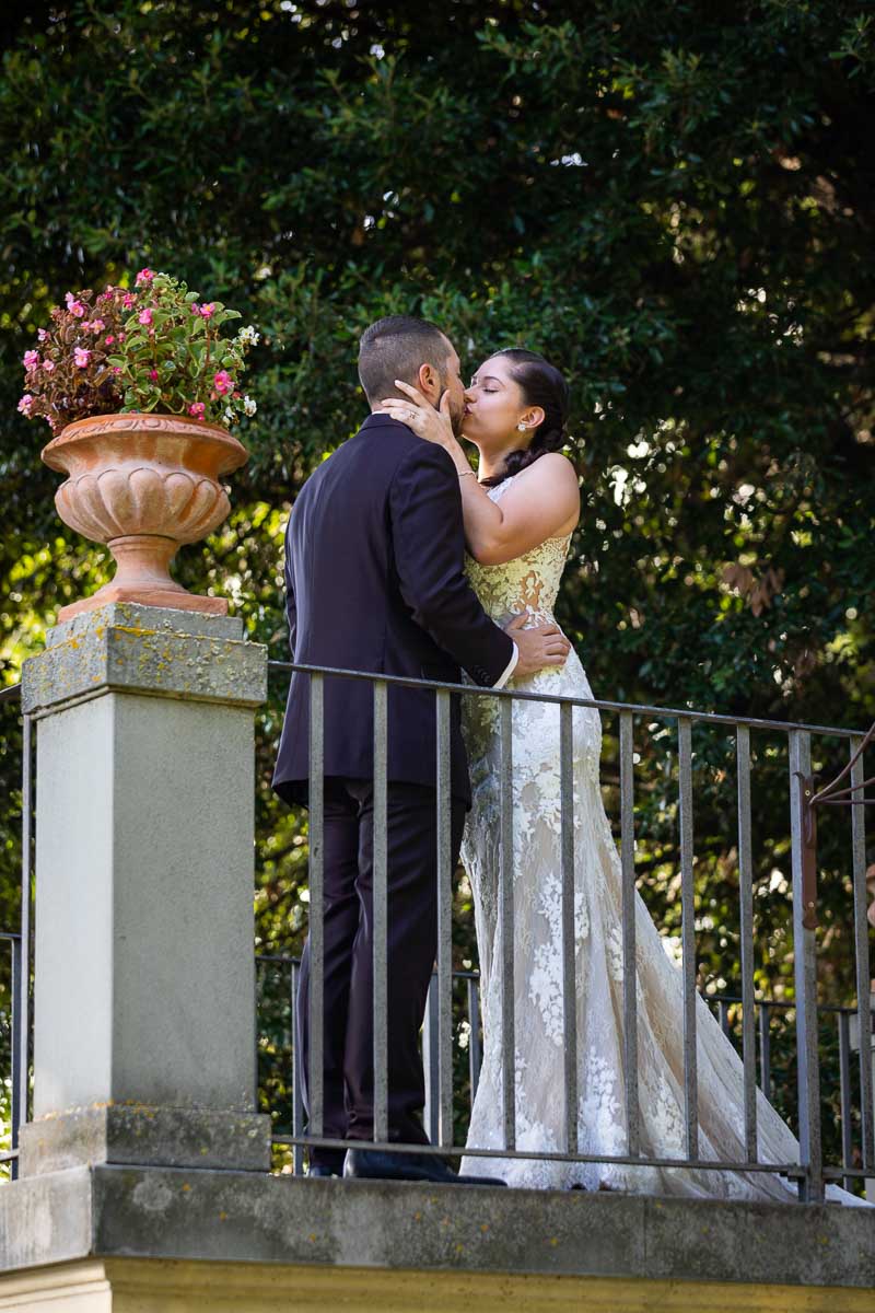 Kissing on a garden terrace overlooking the beautiful green scenery