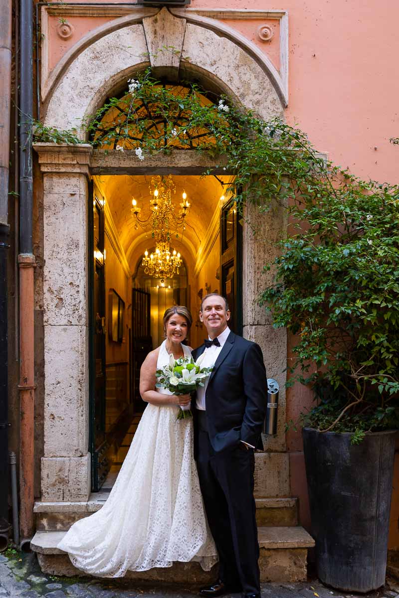 Standing outside the wedding venue taking a portrait picture of the newlyweds