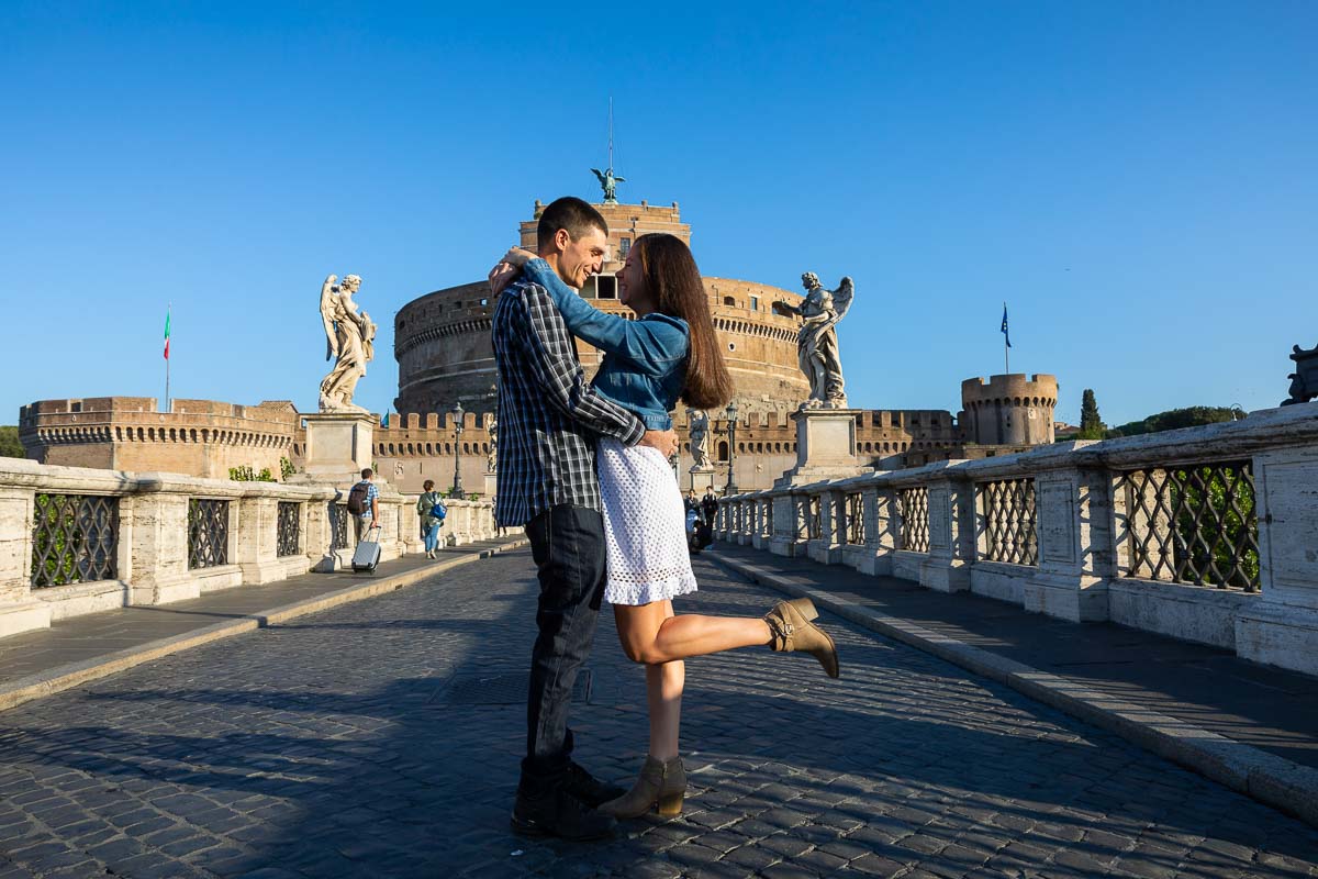 Posed portrait of a couple during an engagement photo shoot in Rome's Castel Sant'Angelo bridge 