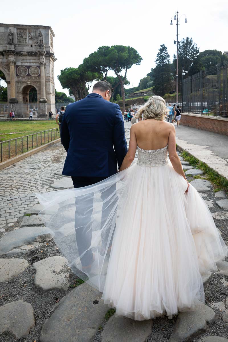 Bride & Groom walking the ancient Rome cobble stones streets