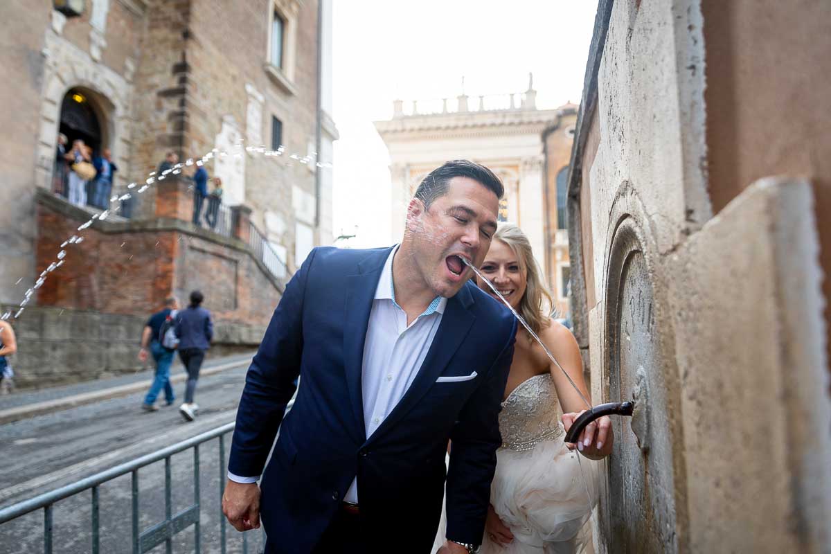 Groom drinking from a water fountain