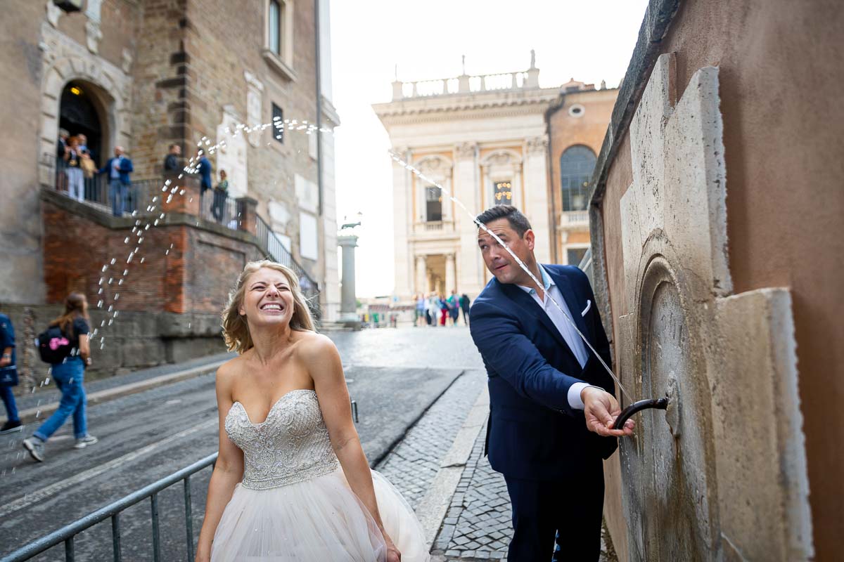 Bride walking underneath water fountain ripple