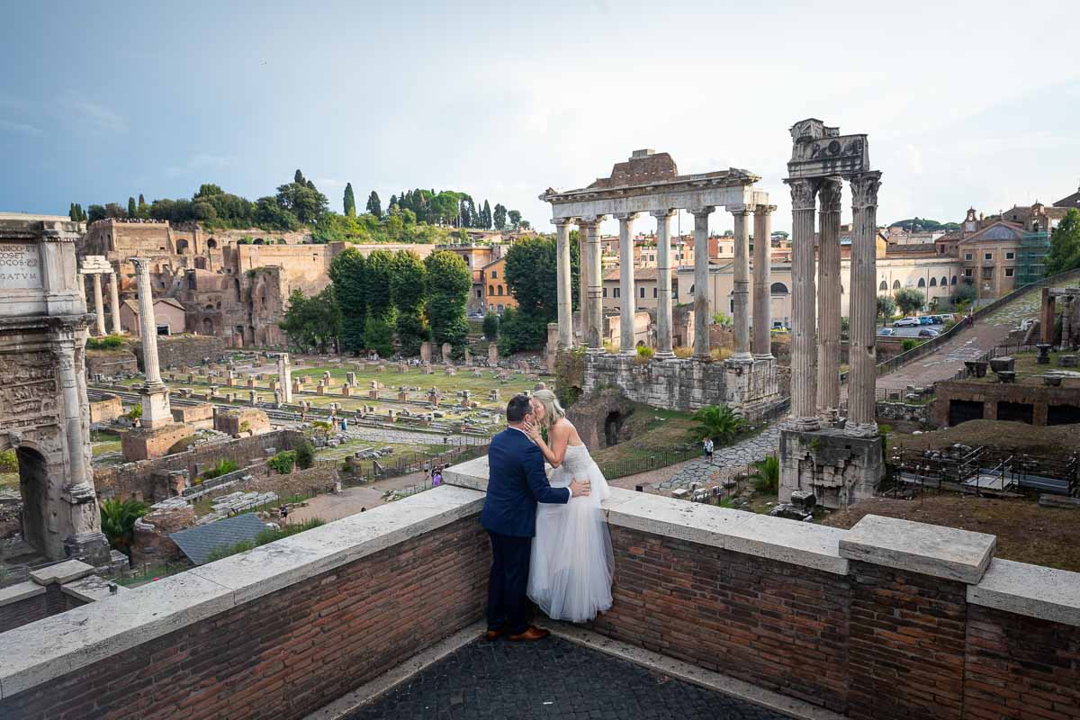 Posing together before the roman forum viewed from the above capitoline hill