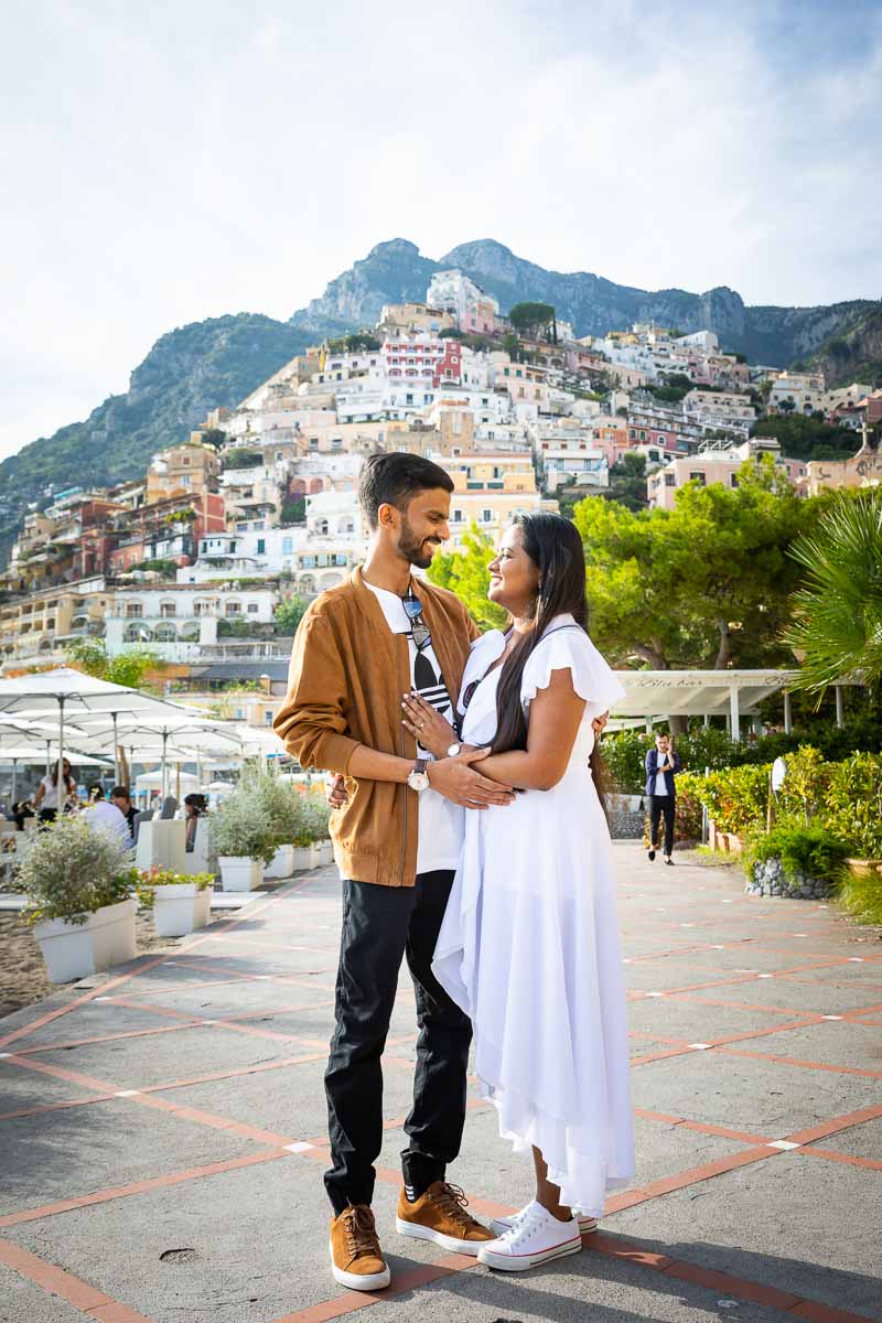 Engagement photoshoot portrait on the boardwalk of Positano with the hillside town in the background