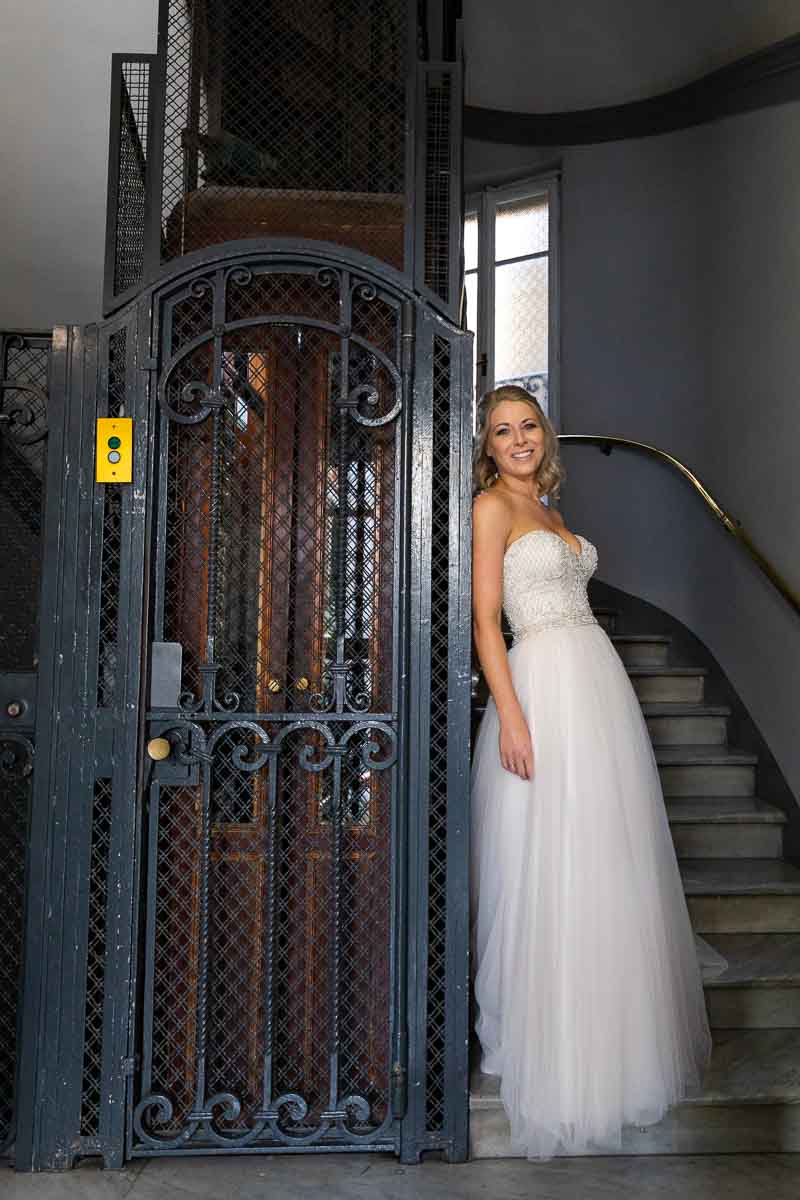 Bride posed next to an iron elevator in nice natural light