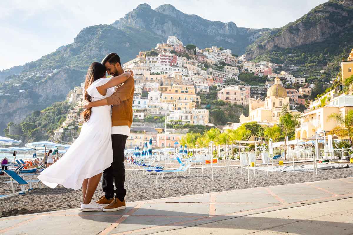 Posed couple on the town beachside taking photos together. Proposal Engagement in Positano