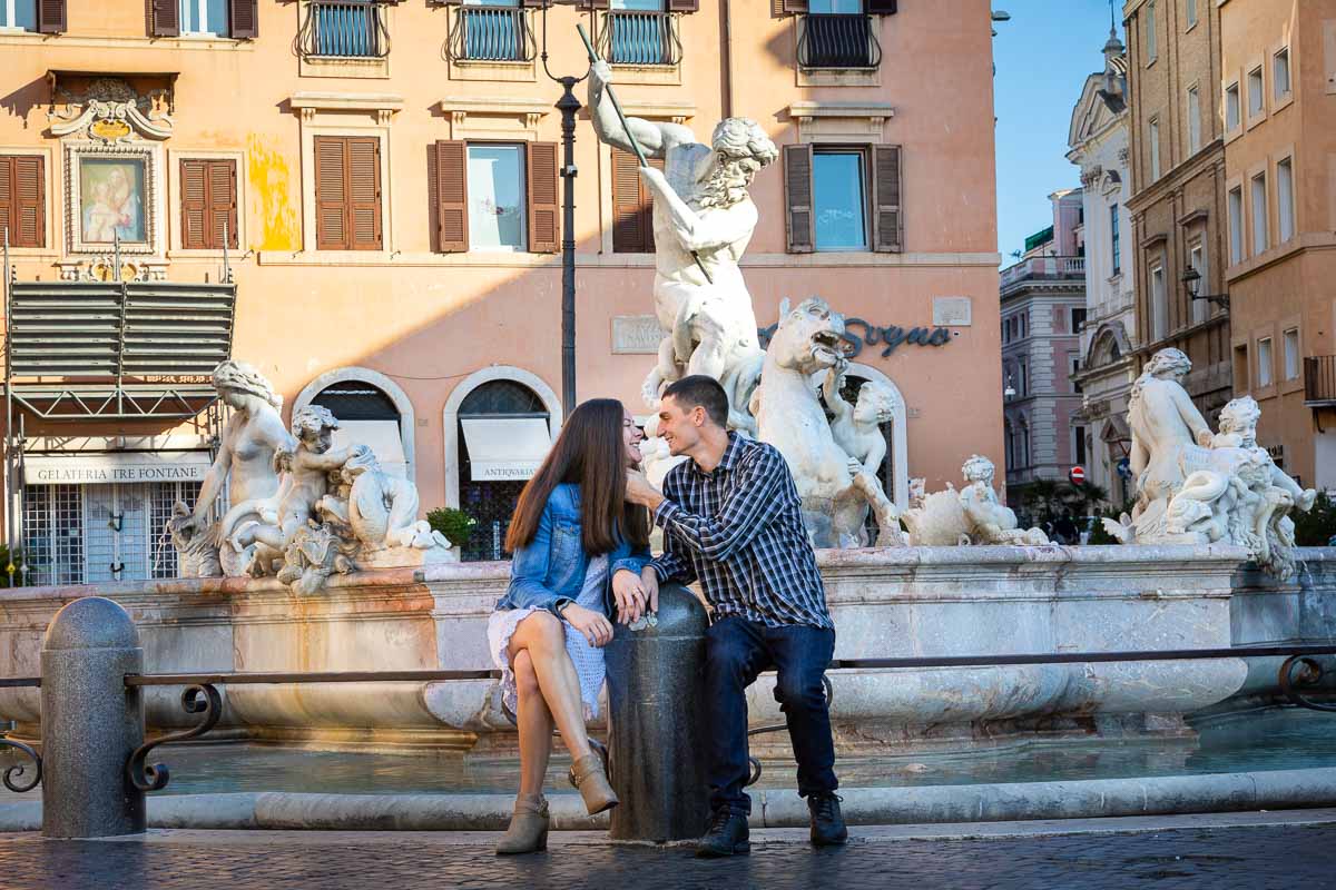 sitting down posing for a picture in Italy's Piazza Navona in the center of Rome