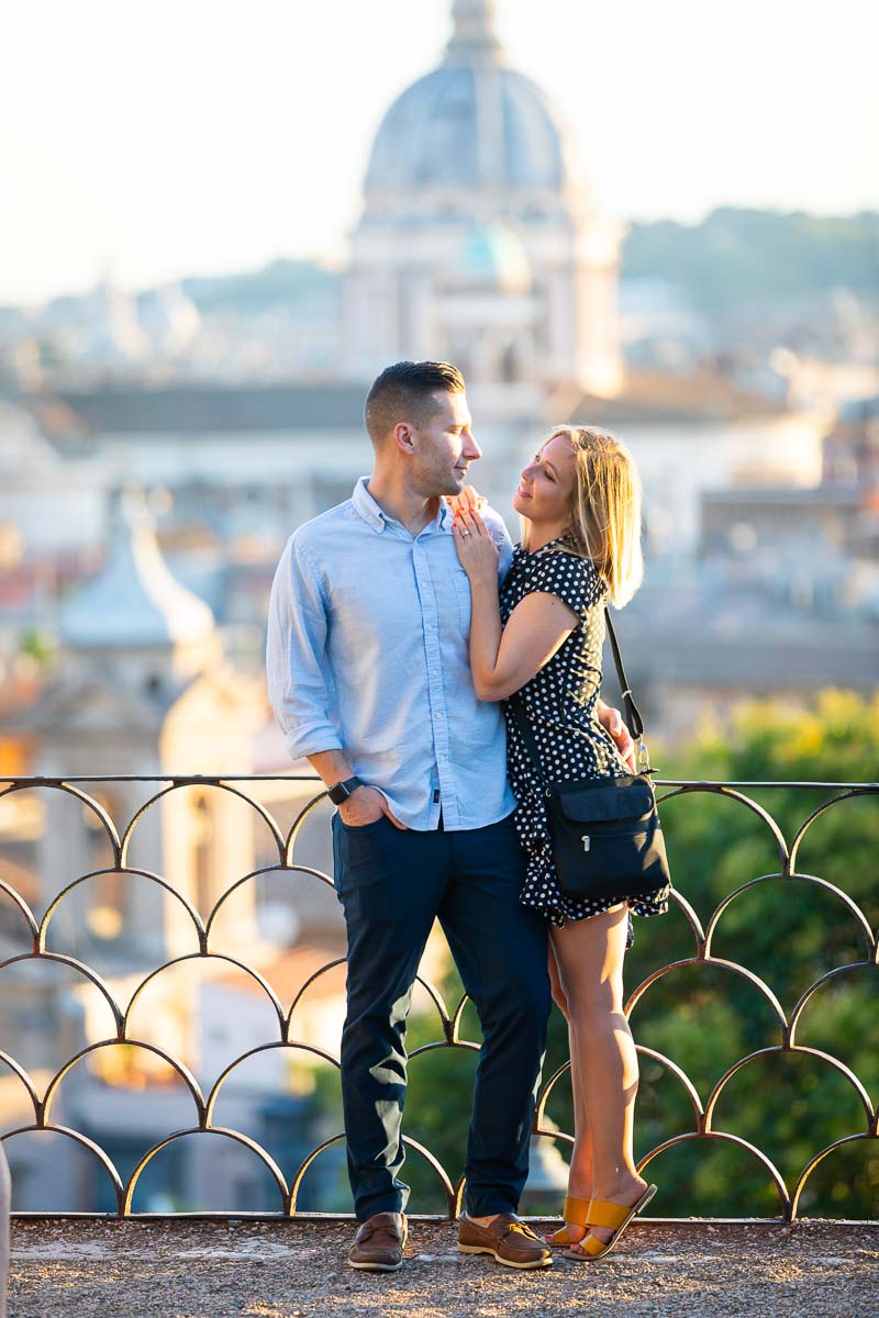Portrait picture of a couple just engaged in Rome Italy taken at Pincio park terrace overlook 