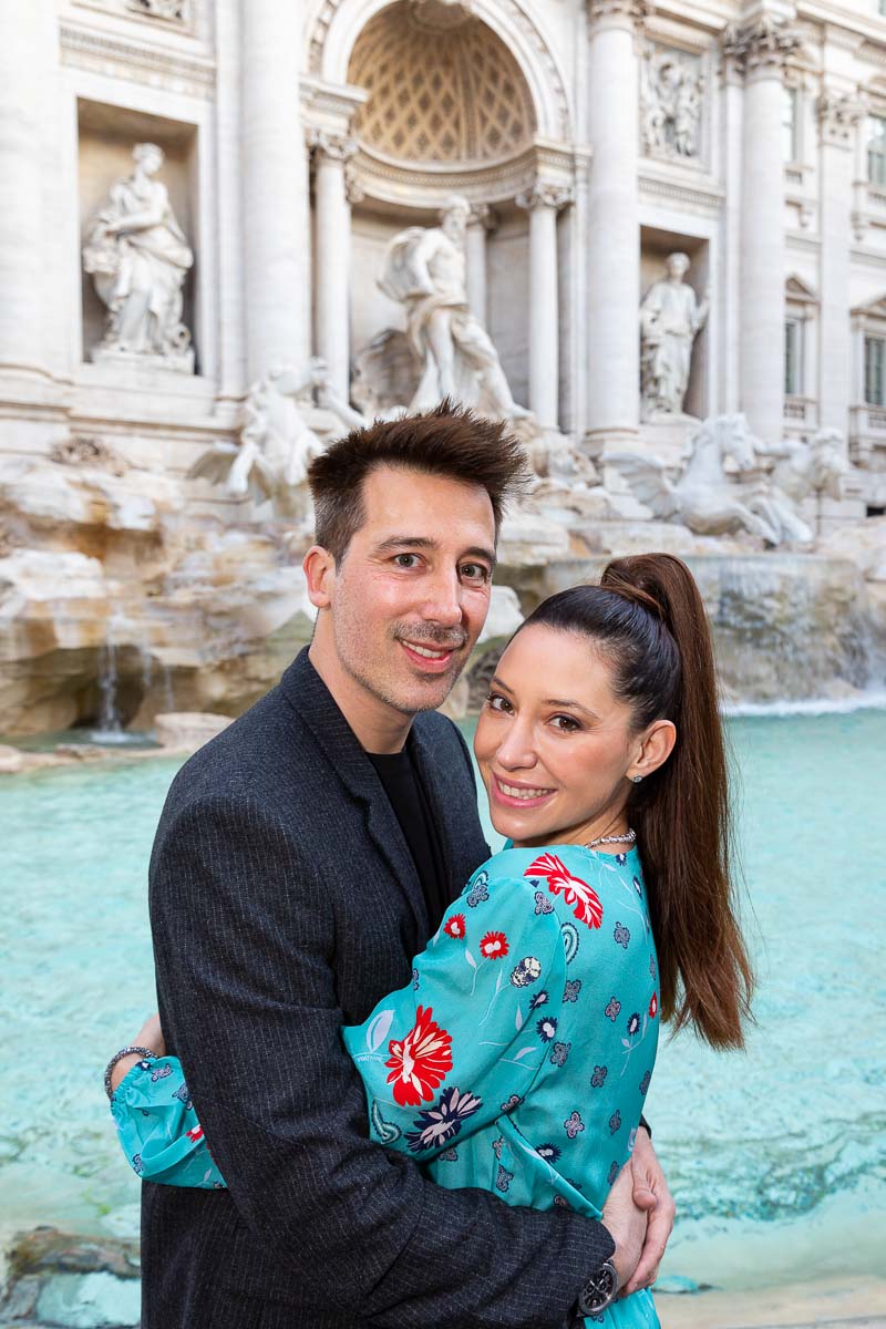 Couple portrait close together photographed in front of the Trevi fountain in Rome Italy