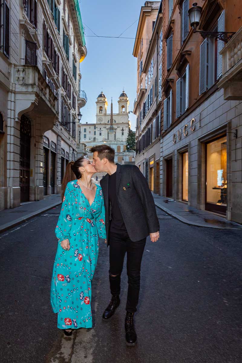 Couple walking together in Via Condotti during a photoshoot in Rome's Fashion district quarter 