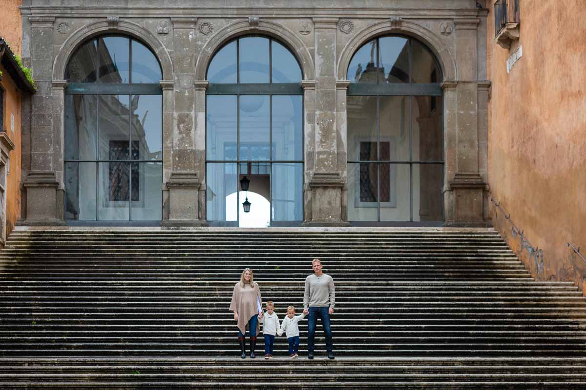 Group standing in the far distance posing on large scenic staircases 