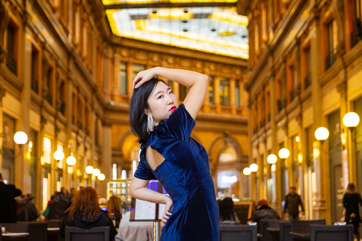 Posing under warm light inside a Gallery in Rome Italy. A great instagrammable place in Rome to take pictures