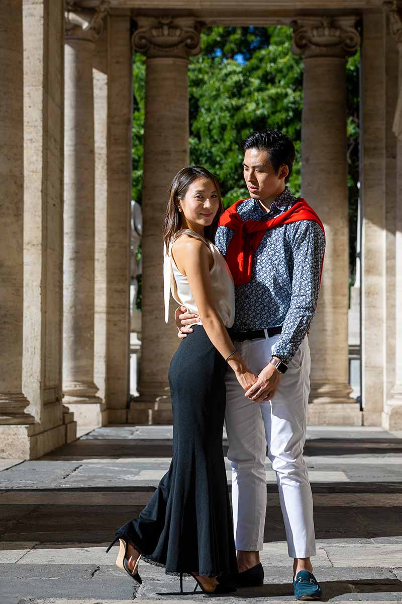 Posed image of a couple photographed under campidoglio portico with lead away columns 