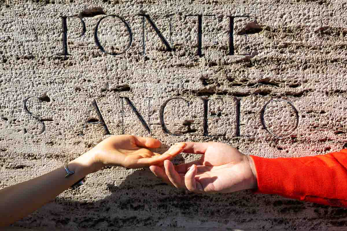 Hands touching at Ponte S. Angelo castle 