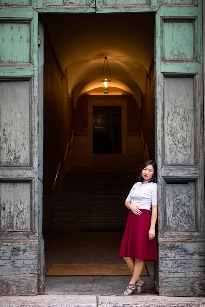 Standing underneath an ancient doorway female model portrait in nice natural light