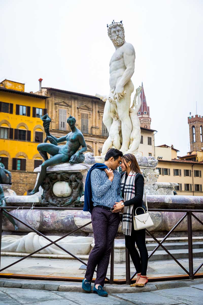 Forehead to forehead pose sideway image with the Florence statue of Neptune in the background
