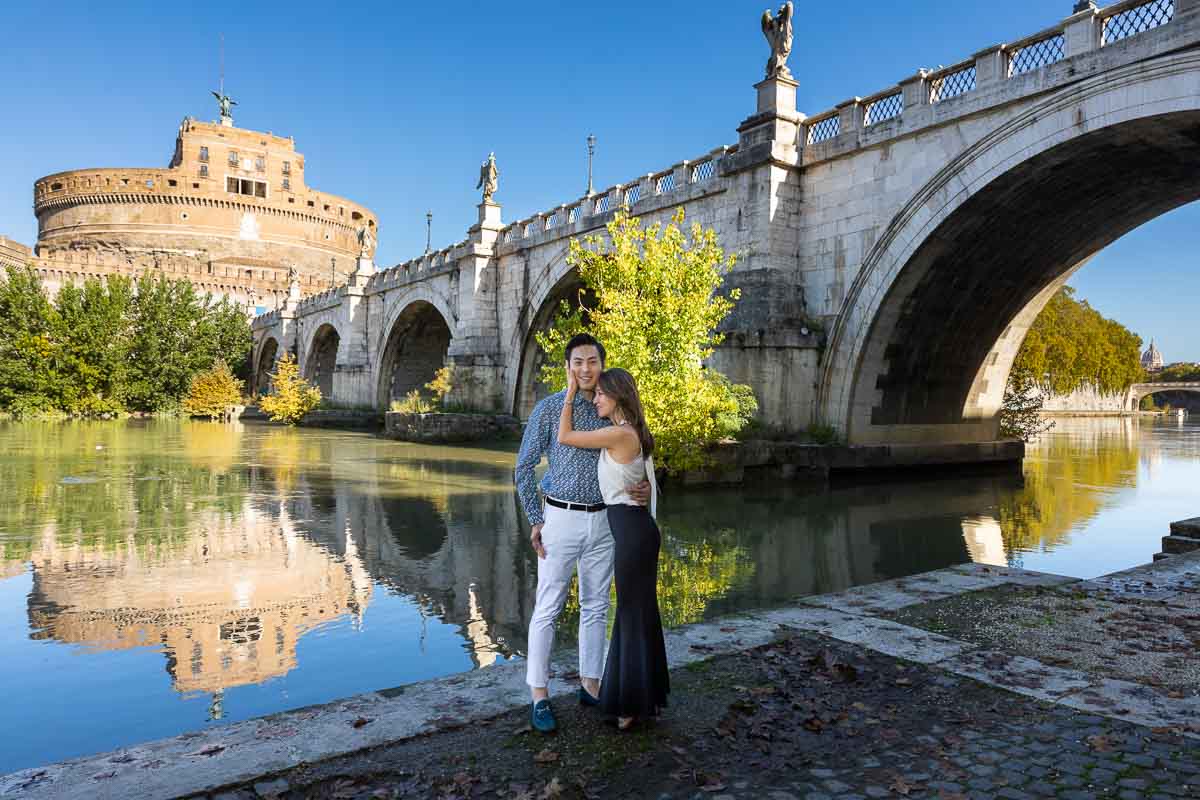 Standing underneath the Castel Sant'Angelo castle and bridge taking portrait photos